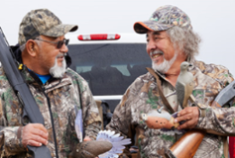 two dove hunters standing by a truck