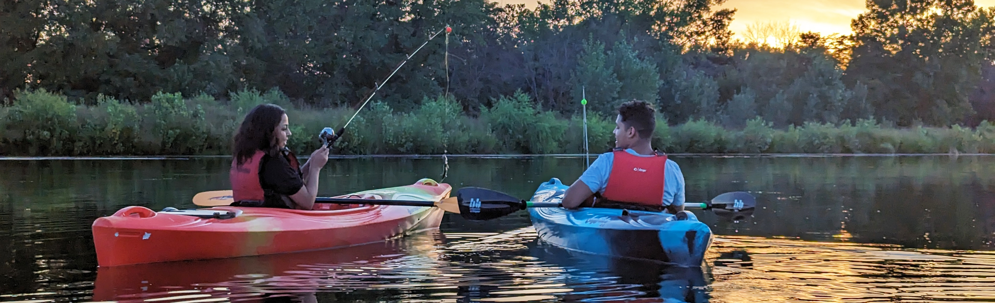 A man and women fishing from kayaks