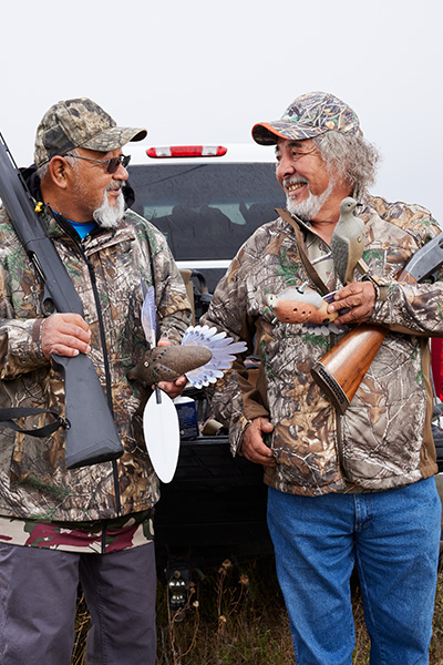 two dove hunters standing by a truck