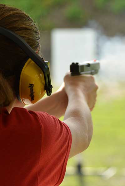 woman firing hand gun