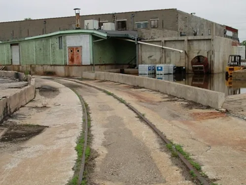 Example of a brownfields site, an old metal warehouse along an abandoned railway track.
