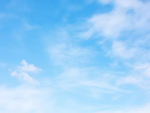 Bright blue sky with wispy clouds