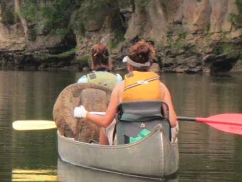 Two people canoe on a lake in Iowa