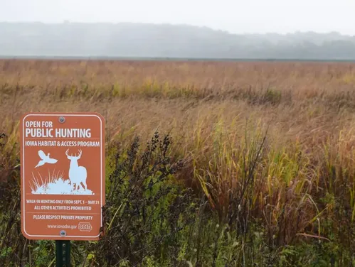 Orange Iowa habitat and access program sign in field.