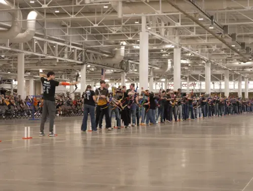 This image shows archers competing at the 2026 Iowa National Archery in the Schools Program State Tournament
