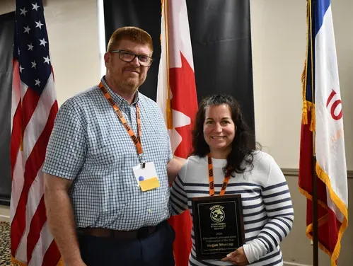 Iowa Department of Natural Resources Education, Outreach, and Marketing Section Supervisor, Megan Taube (right), is awarded the Midwest Association of Fish & Wildlife Agencies (MAFWA) Education Professional of the Year, by Iowa DNR’s Division Administrator Pete Hildreth, during the association’s meeting June 21-24, in Okoboji. 