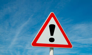 Triangular warning sign with red border and an exclamation point in the center.