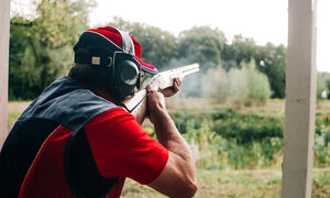 Someone taking a practice shot at a range.