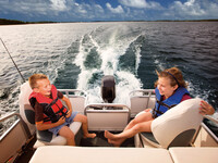 Kids wearing lifejackets on a boat
