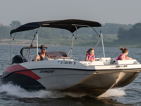 Summertime fun on the water with motor boat, kids in lifejackets.