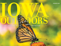 Iowa Outdoors magazine cover image with butterfly on a flower.