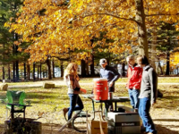 A group of adults camping at an Iowa State Park in the fall