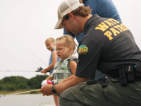 water patrol officer fishing with youth
