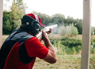 Someone taking a practice shot at a range.