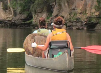 Two people canoe on a lake in Iowa