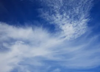 Wispy clouds on a dark blue sky.