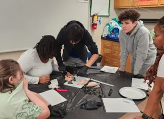 Students getting a hands on learning experience with fish anatomy, reproduction, and organ function.