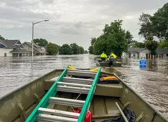 This image shows flooding in a residential area in Rock Valley, Iowa from a boaters perspective 