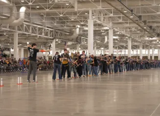 This image shows archers competing at the 2026 Iowa National Archery in the Schools Program State Tournament