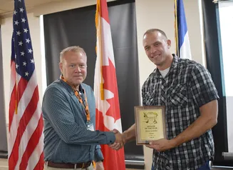 Col. Craig Cutts (left) presents Sgt. Steve Griebel officer of the year award during annual meeting in Okoboji