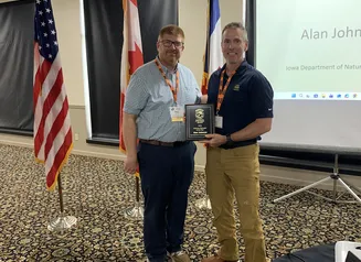 Iowa Department of Natural Resources Fish Culture Research Biologist, Alan Johnson (right) is awarded the Midwest Association of Fish & Wildlife Agencies (MAFWA) Fisheries Biologist of the Year, by Iowa DNR’s Division Administrator Pete Hildreth