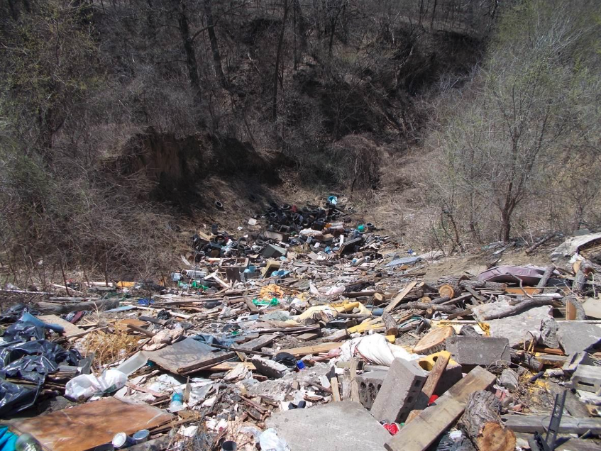 This image shows illegal dumping of waste in a ditch