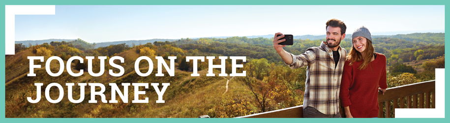 Focus on the journey, parks passport image with couple taking selfie.